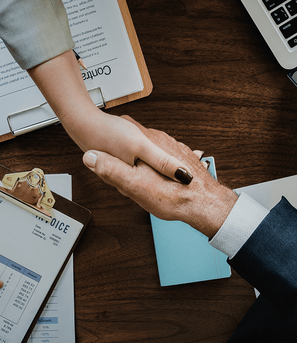 Close up of a lawyer and client shaking hands after reaching a legal agreement