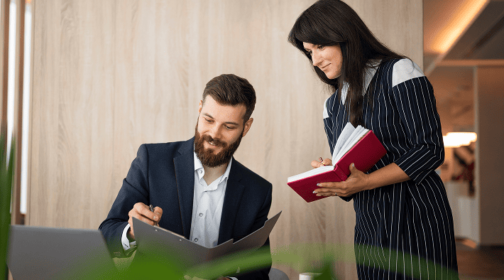 Couple sitting together and carefully reviewing legal family law documents