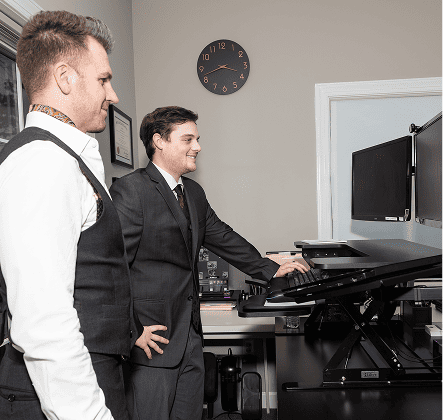 Two lawyers walking and discussing a legal case in the office hallway