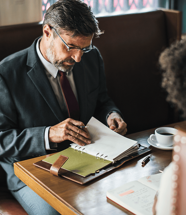 Professional lawyer carefully reviewing legal documents at his desk